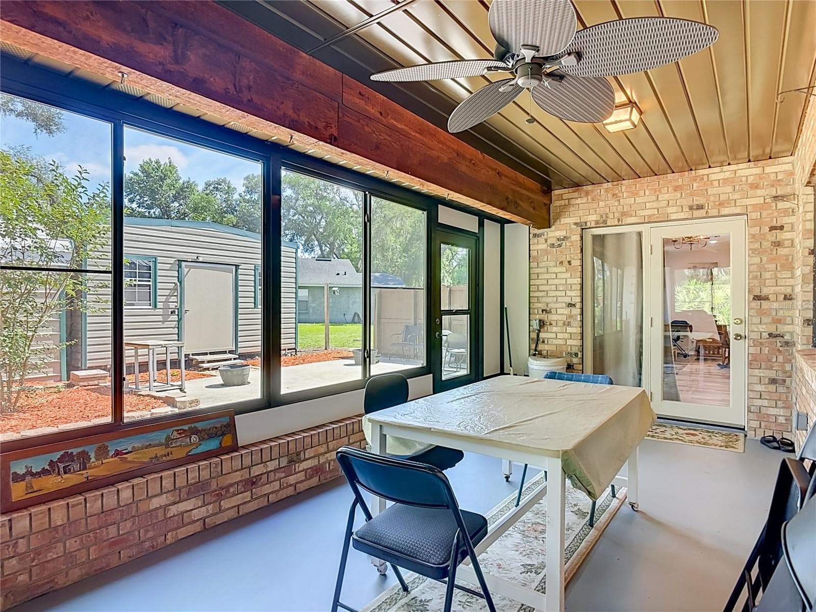 French doors lead out to enclosed back porch with electric and views of bakyard - 17819 PALM ST, UMATILLA