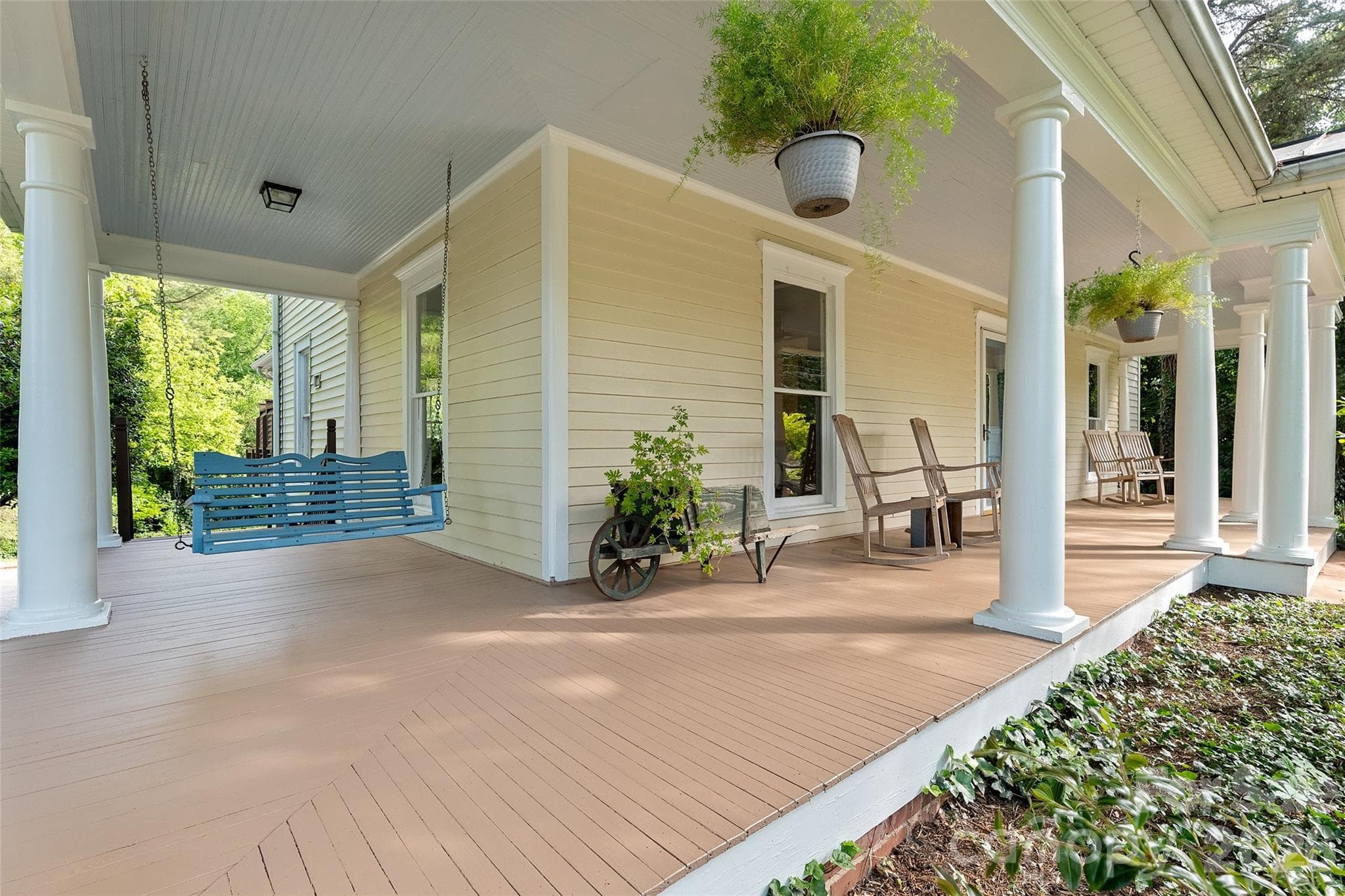 Timeless two-story Colonial Revival featuring a wraparound porch with classical columns and a pedimented entry. Ideally located just steps from Davidson College and all that downtown Davidson has to offer. - 602 N Main Street, Davidson