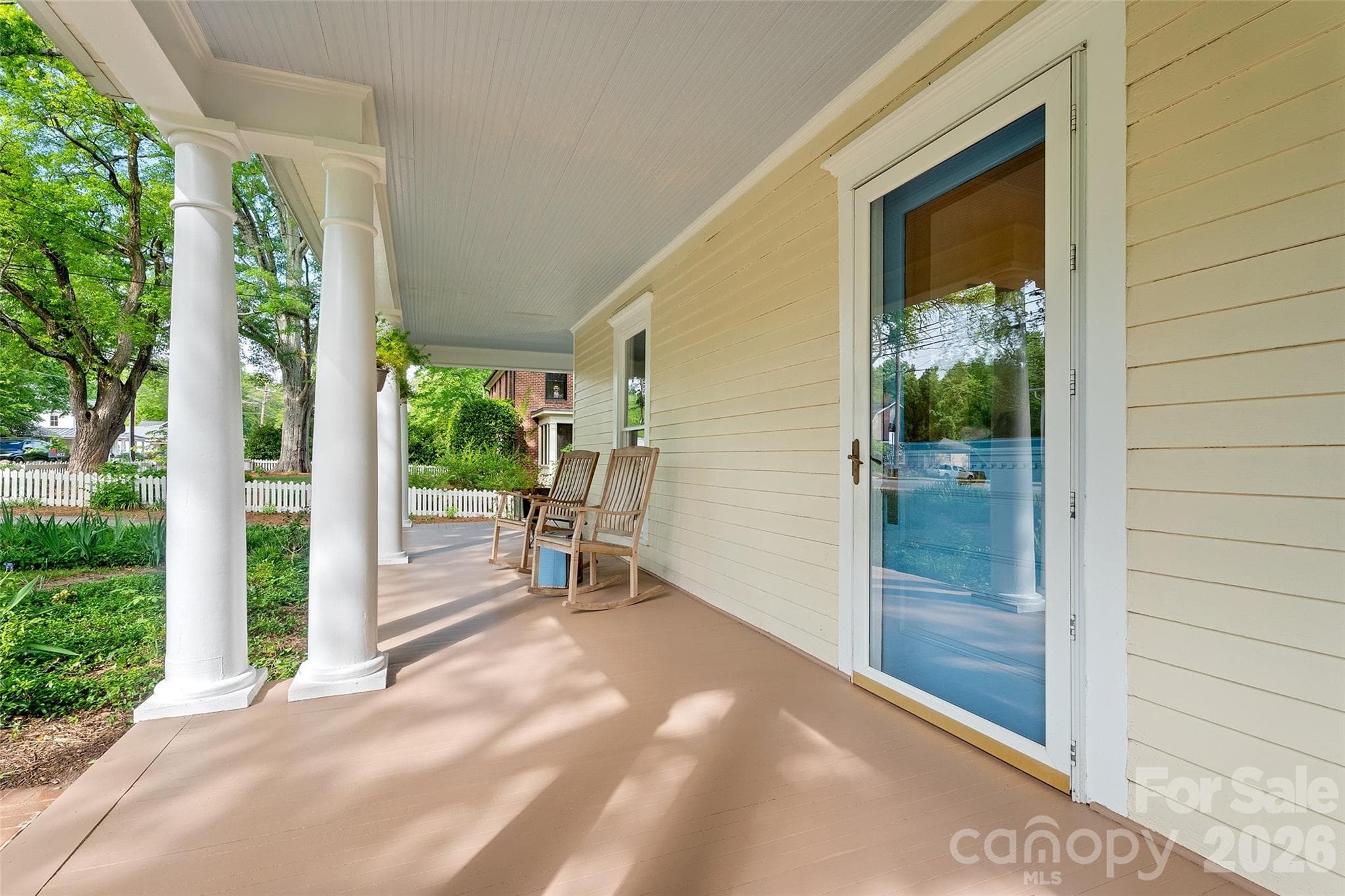 Timeless two-story Colonial Revival featuring a wraparound porch with classical columns and a pedimented entry. Ideally located just steps from Davidson College and all that downtown Davidson has to offer. - 602 N Main Street, Davidson