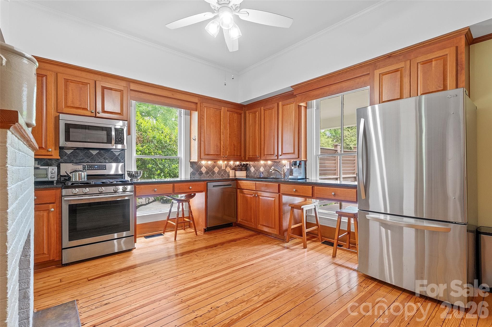 The classically updated kitchen offers high-quality wood cabinetry, granite countertops, and a design that honors the home’s history while supporting modern use. - 602 N Main Street, Davidson