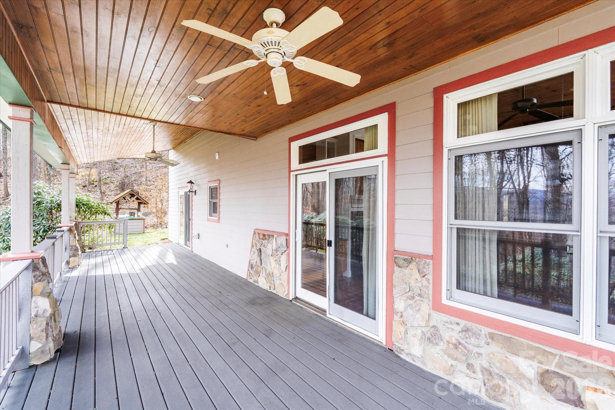 Covered side porch with tongue & groove ceiling and fans to keep cool during the warm months is the perfect place to relax & take in the views. - Waynesville