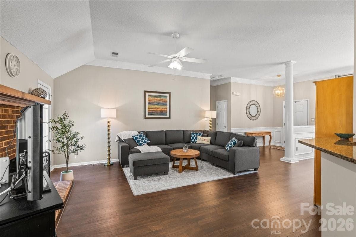 Spacious living room with laminate wood flooring and a layout that lives well for everyday life and entertaining - Charlotte