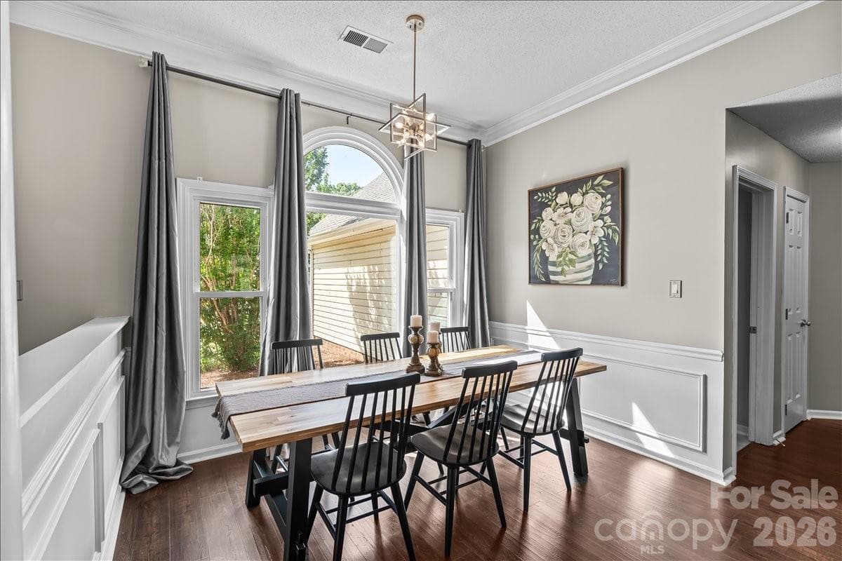 Dedicated dining area anchored by the beautiful arched front windows, open to the living room and kitchen - Charlotte