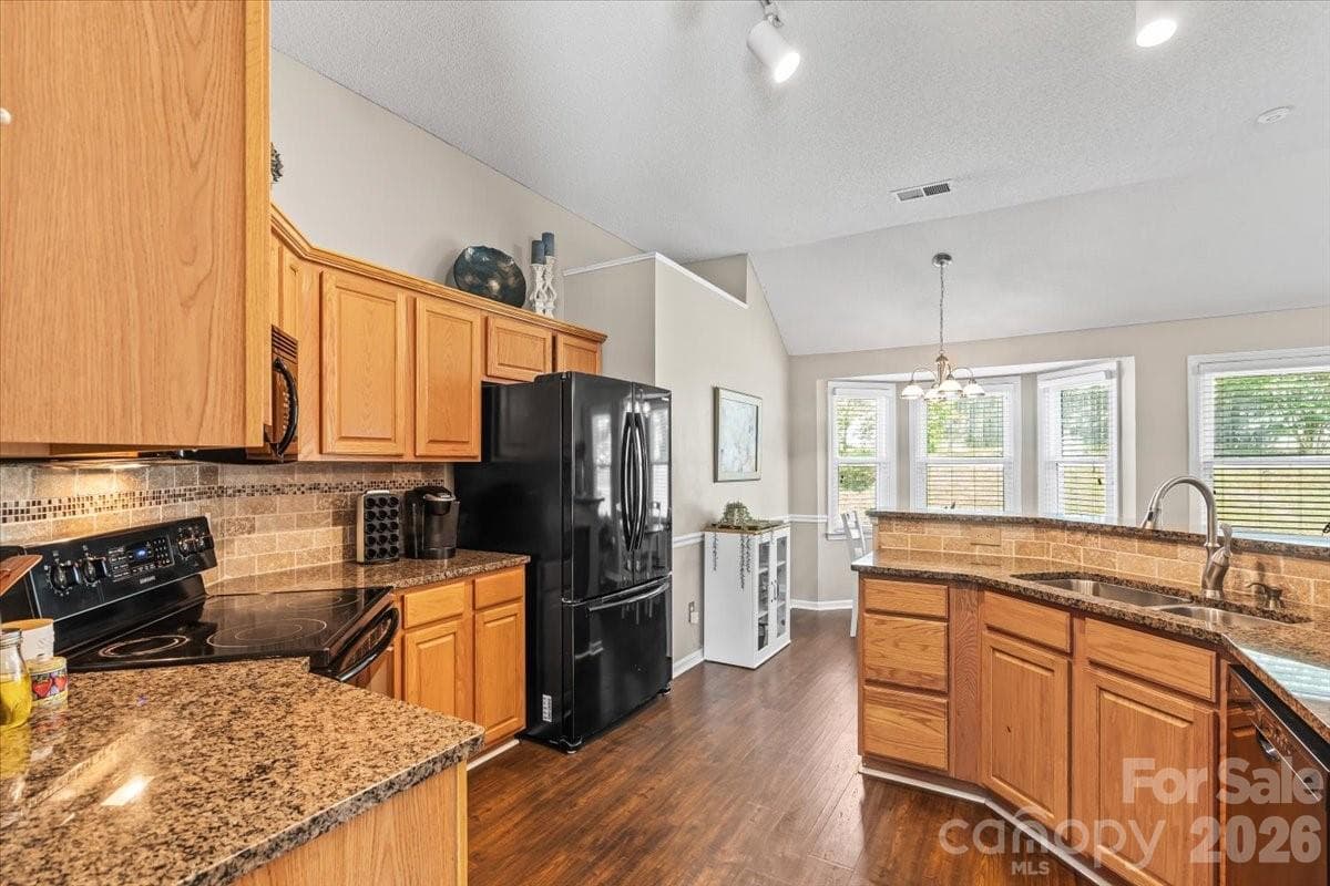 Generous upper and lower cabinet storage and a pantry mean everyday cooking and prep stays easy and organized - Charlotte