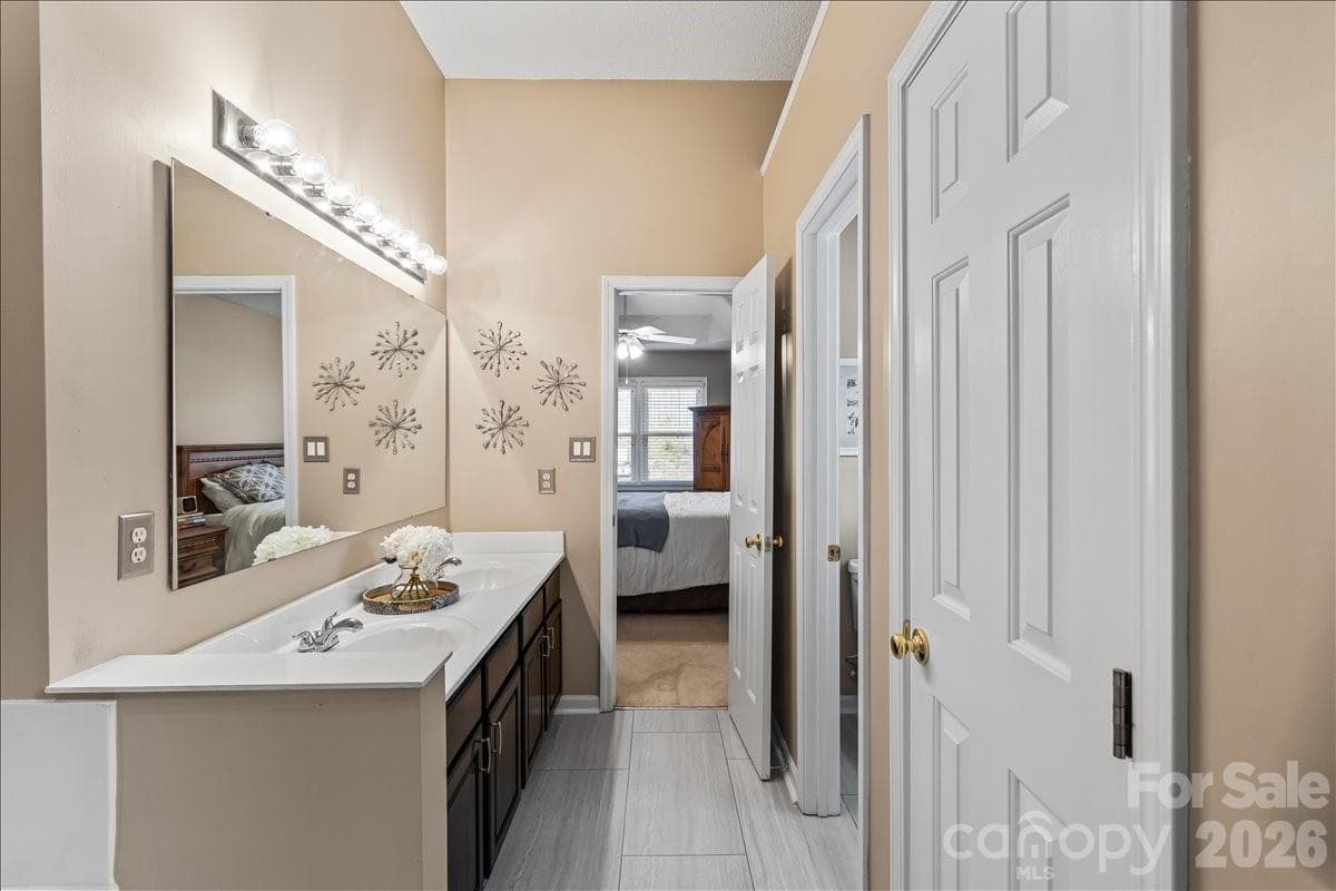 Tile flooring ~2023 and a double vanity offer everyday function with a clean, refreshed look - Charlotte