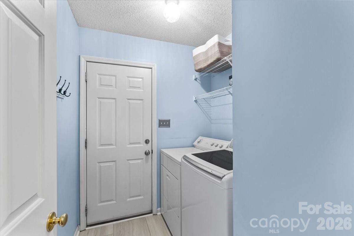 Enter from the 2-car garage, through the laundry room, with updated tile flooring ~2023 and quick access straight through to the kitchen - Charlotte