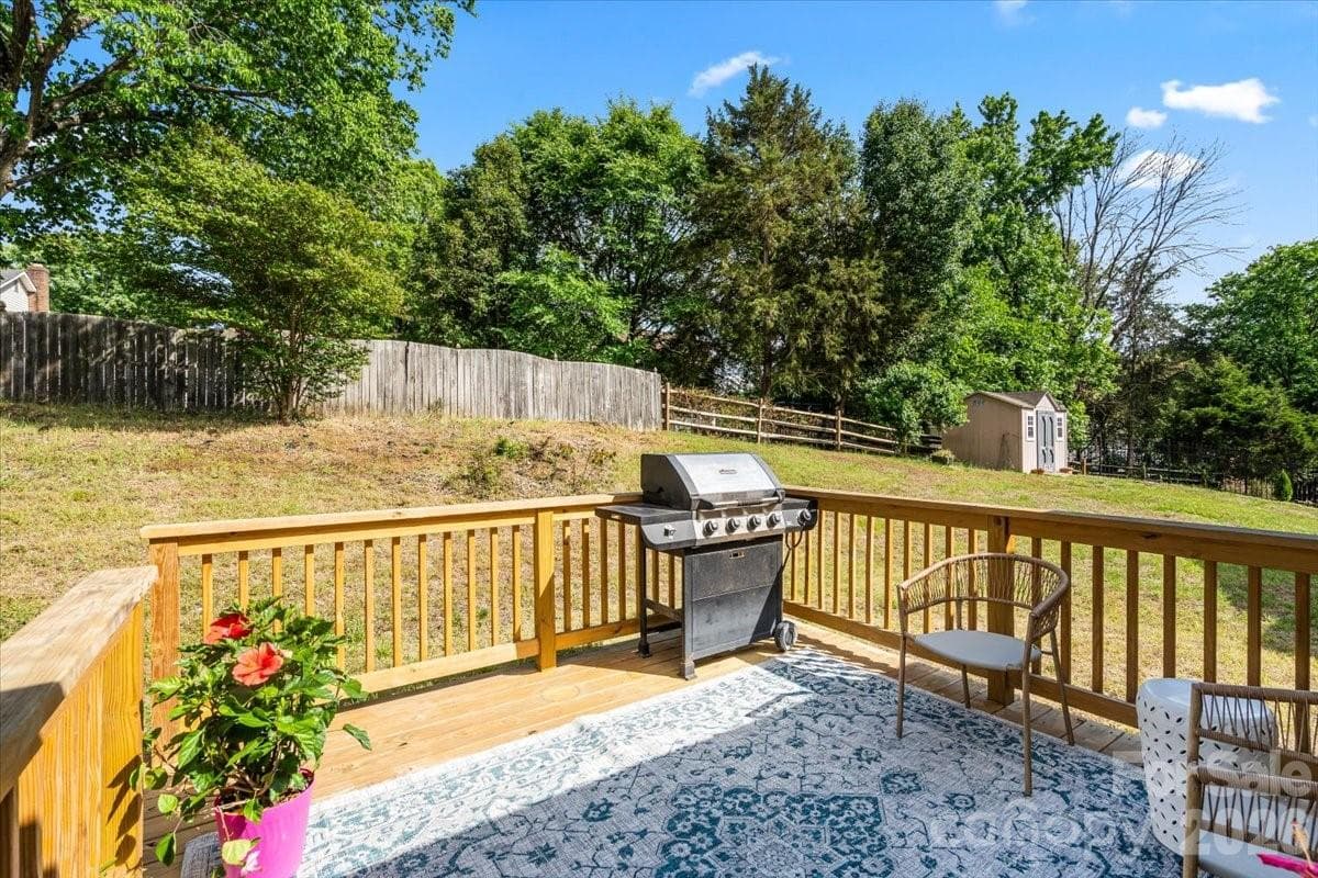 Enjoy the afternoon on the new deck (2024) overlooking the yard with mature trees behind. - Charlotte