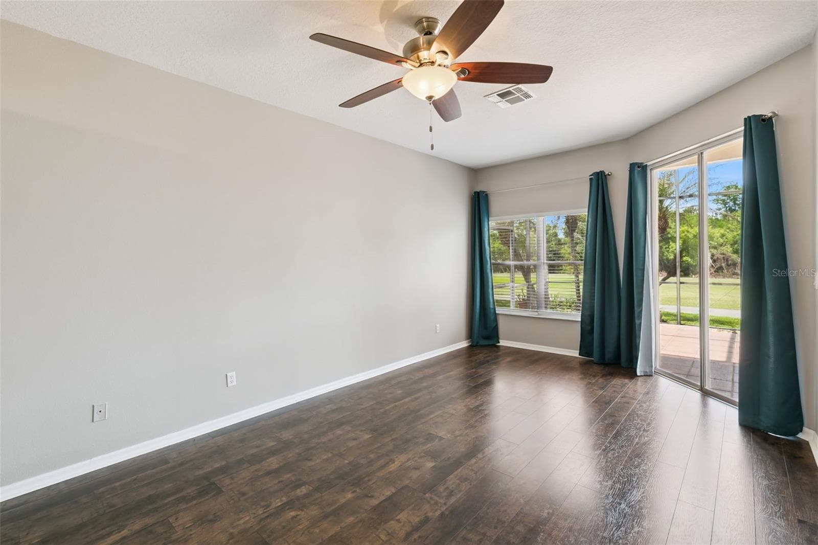 Primary bedroom with entrance to screened patio. - 237 STRATHMORE CIR, KISSIMMEE