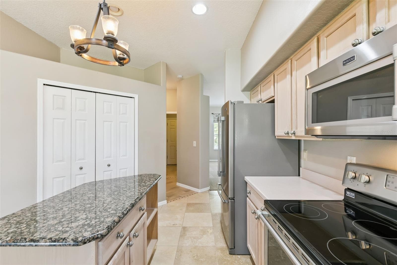 View of the large front rooms looking through the kitchen. Large pantry on the left. - 237 STRATHMORE CIR, KISSIMMEE