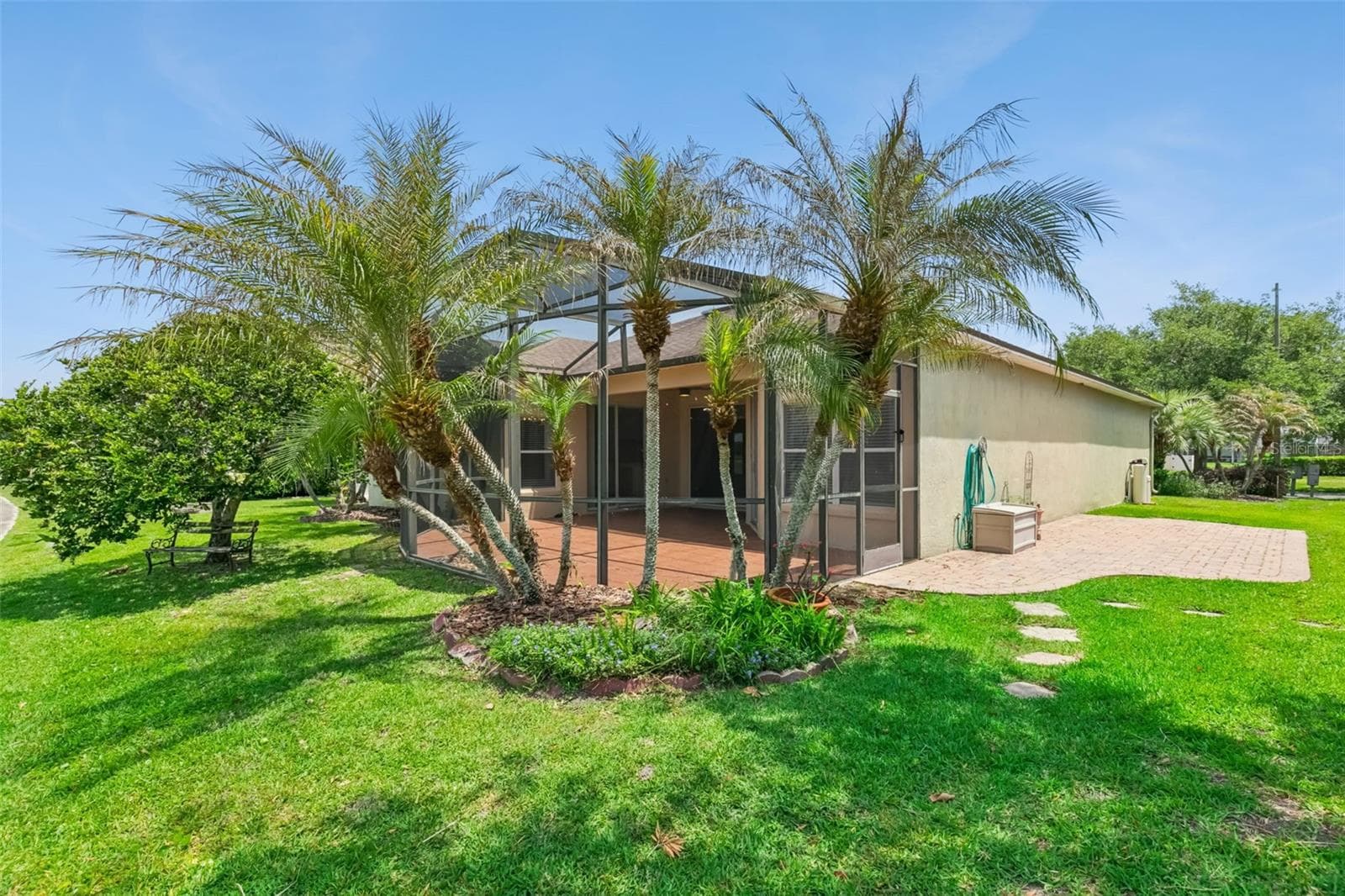 Rear view from cart path, facing the patio entrance and extra outside seating. - 237 STRATHMORE CIR, KISSIMMEE