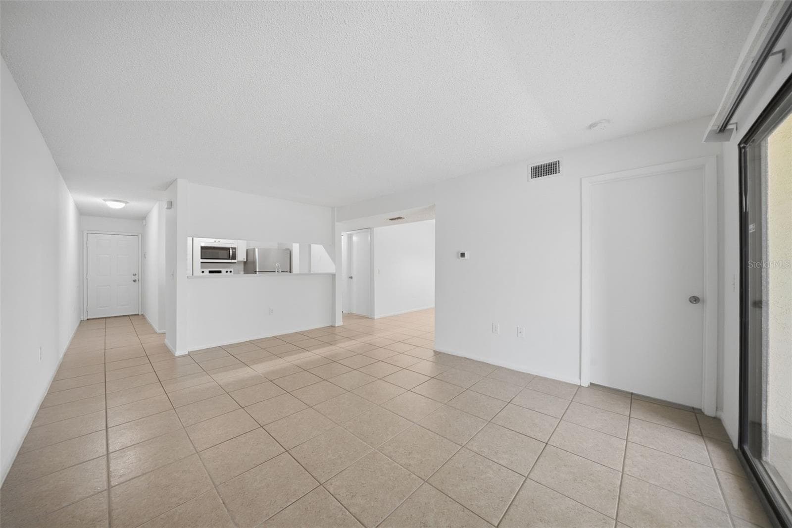 Living room to kitchen and dining room - 3001 58TH AVE S #1005, ST PETERSBURG