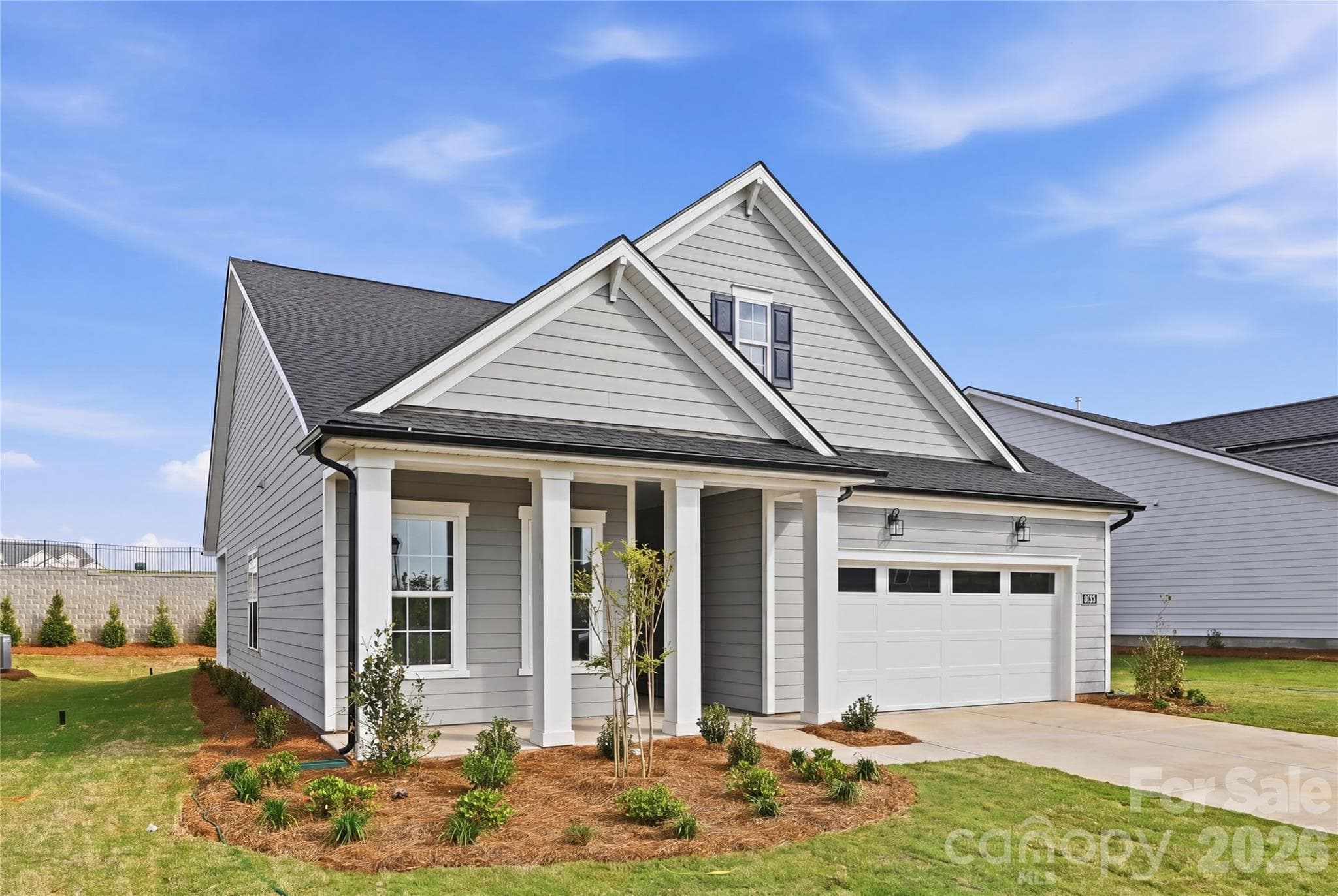 Covered front porch with impressive architectural columns - Indian Land
