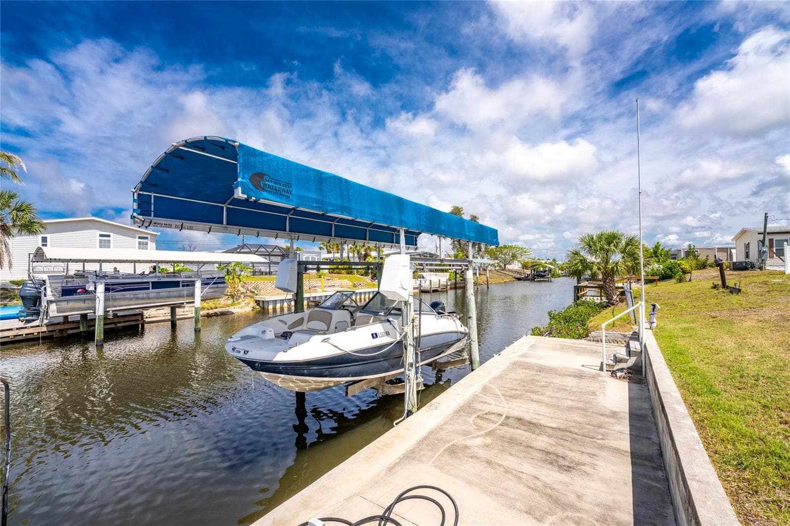 Concrete apron and boat lift with cover - 1380 SEAGULL DR, ENGLEWOOD