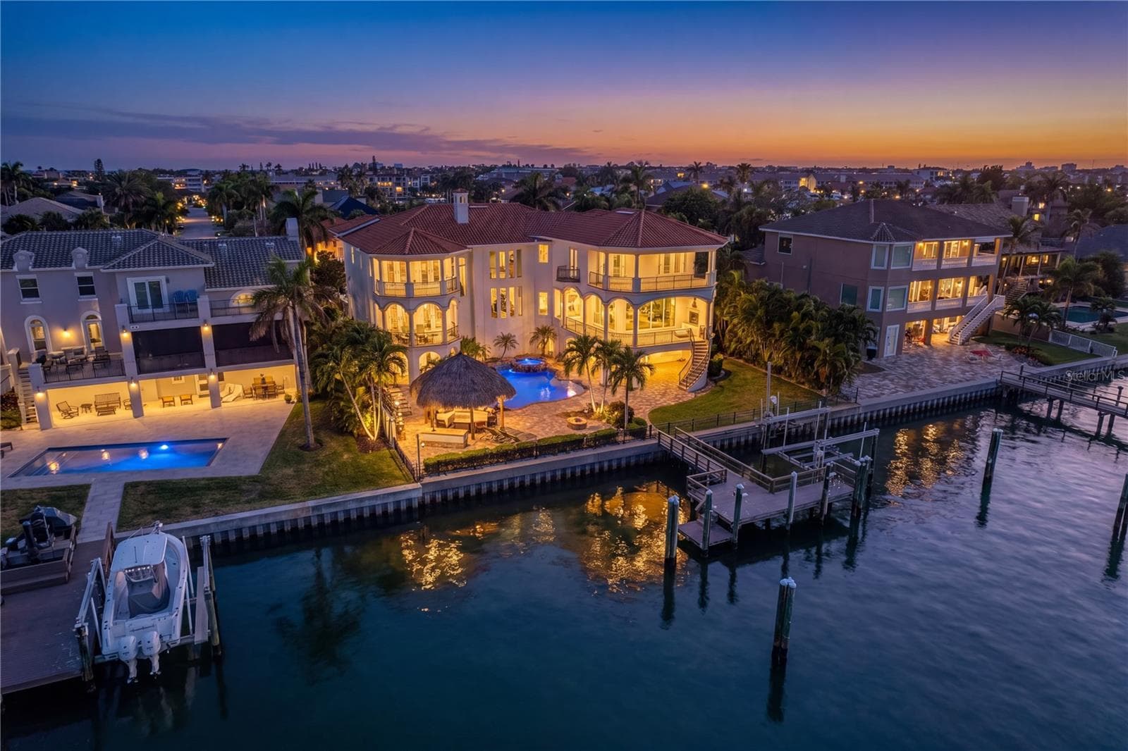 Stunning twilight view of the rear elevation of this exceptional Tierra Verde residence. - 611 1ST AVE S, TIERRA VERDE