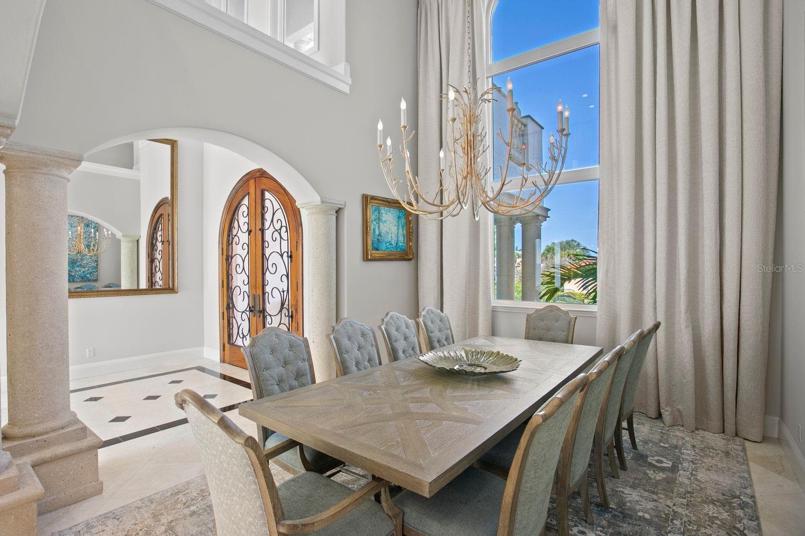 Elegant dining room just off the entry, framed by double glass doors. - 611 1ST AVE S, TIERRA VERDE