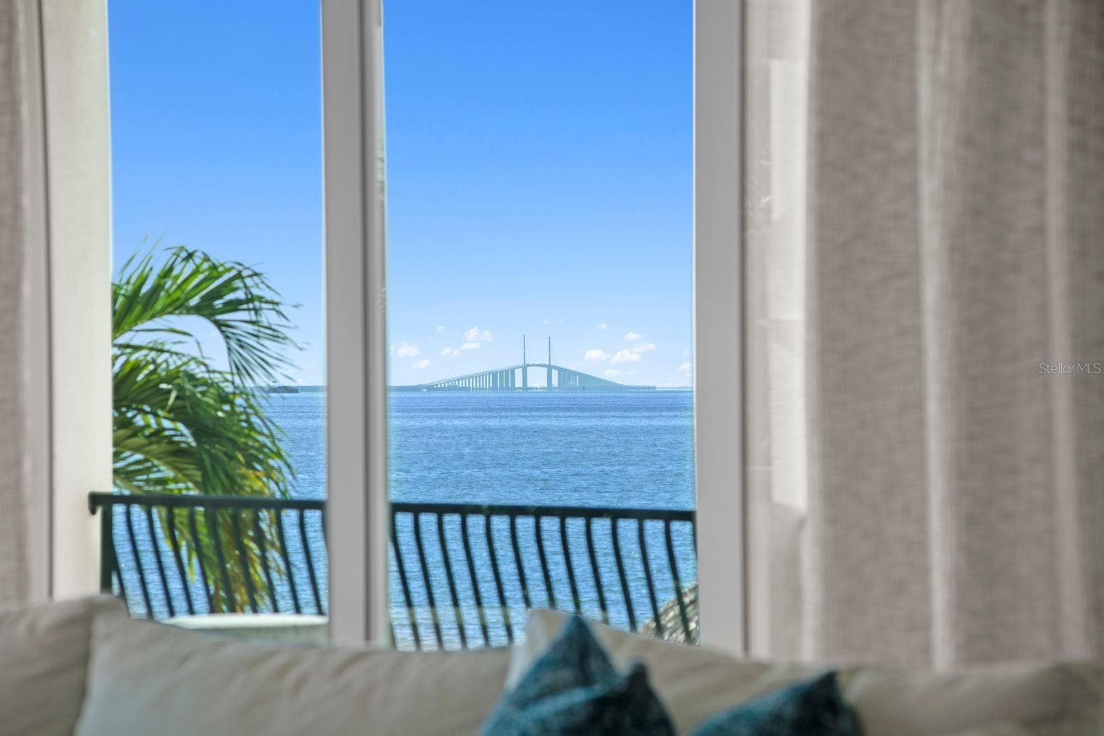 Sweeping views of the Sunshine Skyway Bridge create a striking backdrop from the family room. - 611 1ST AVE S, TIERRA VERDE