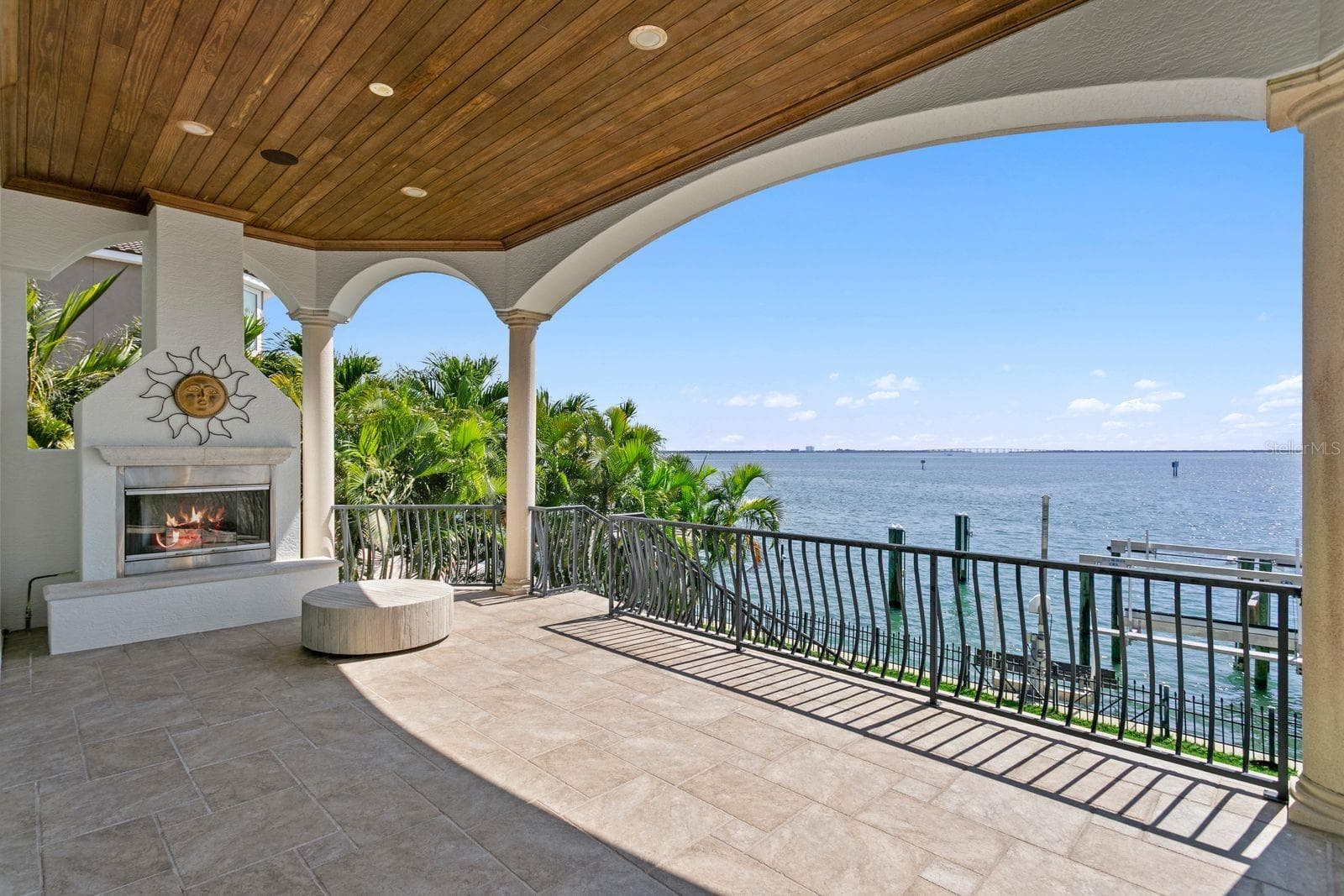 This gorgeous balcony off the family room, with an outdoor fireplace provides the perfect setting for morning coffee or evening cocktails. - 611 1ST AVE S, TIERRA VERDE