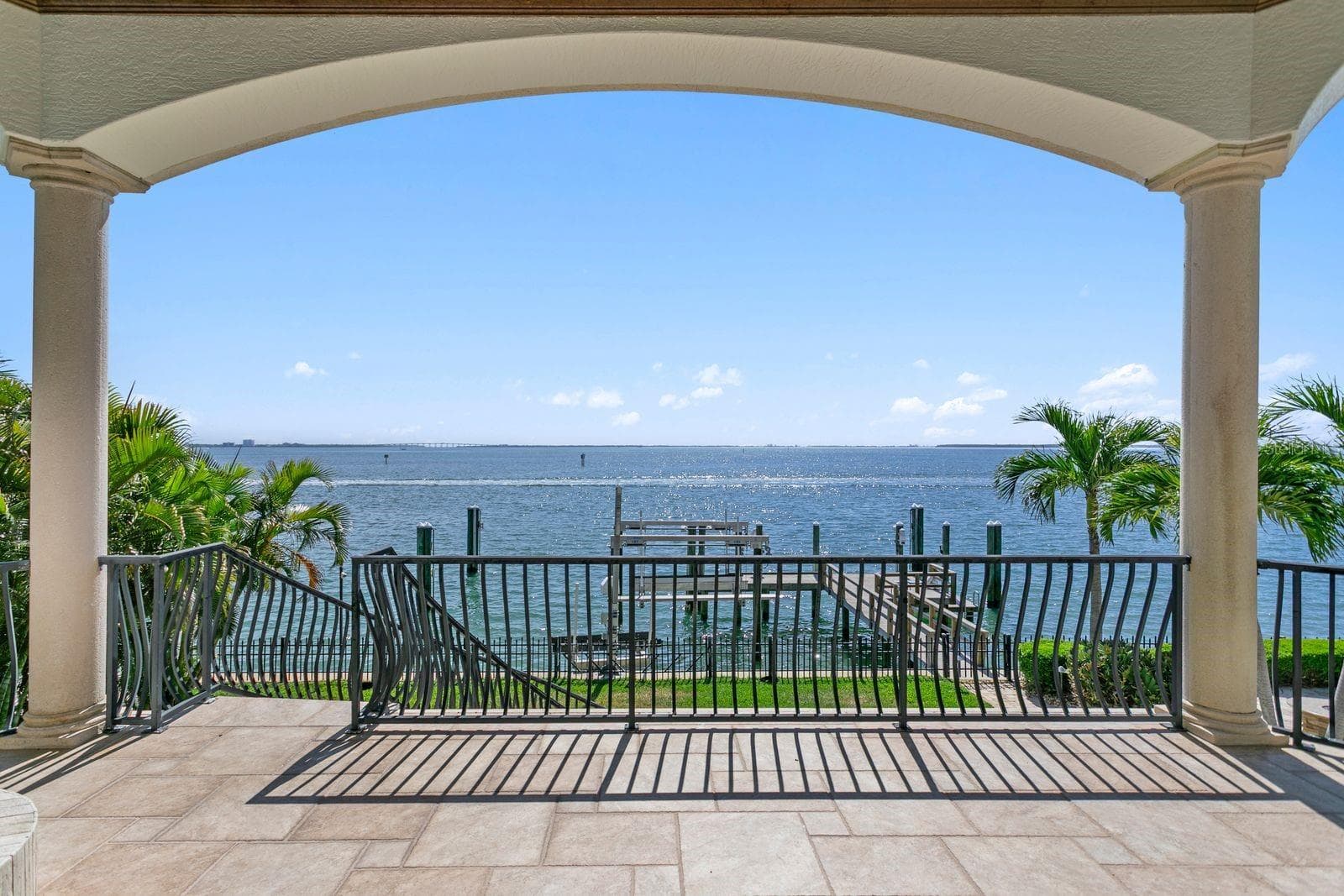 View from the balcony off of the family room, overlooking the dock and sparkling water. - 611 1ST AVE S, TIERRA VERDE