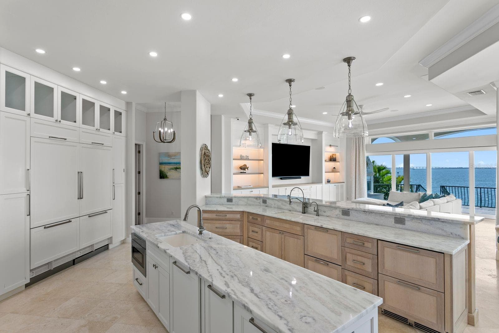 The elegant kitchen showcases stunning Tampa Bay views, custom cabinetry and fully integrated paneled refrigerator. - 611 1ST AVE S, TIERRA VERDE