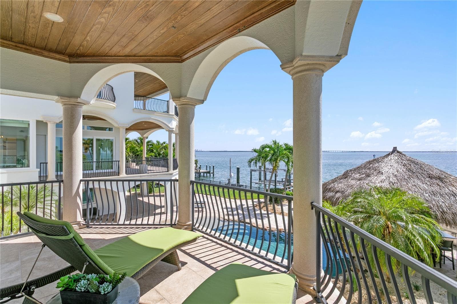 Private balcony off the main level primary suite, overlooking sparkling waters. - 611 1ST AVE S, TIERRA VERDE