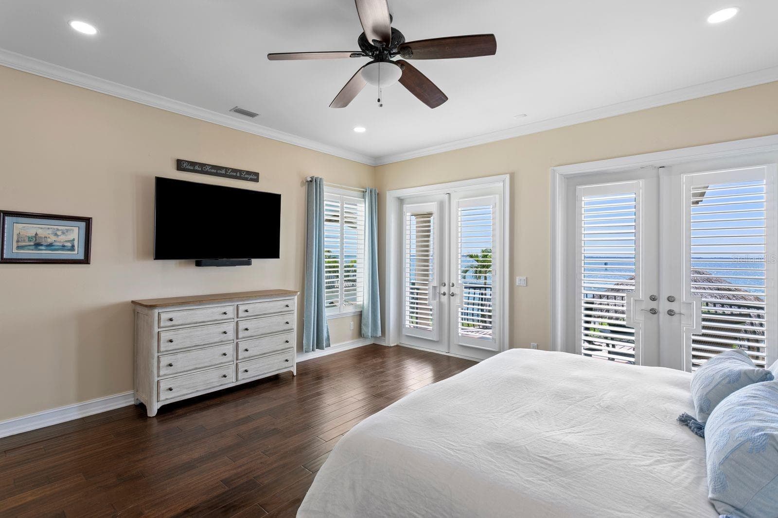 Another view of the main level, primary suite, highlighting the glass sliders, large balcony and views of Tampa Bay. - 611 1ST AVE S, TIERRA VERDE