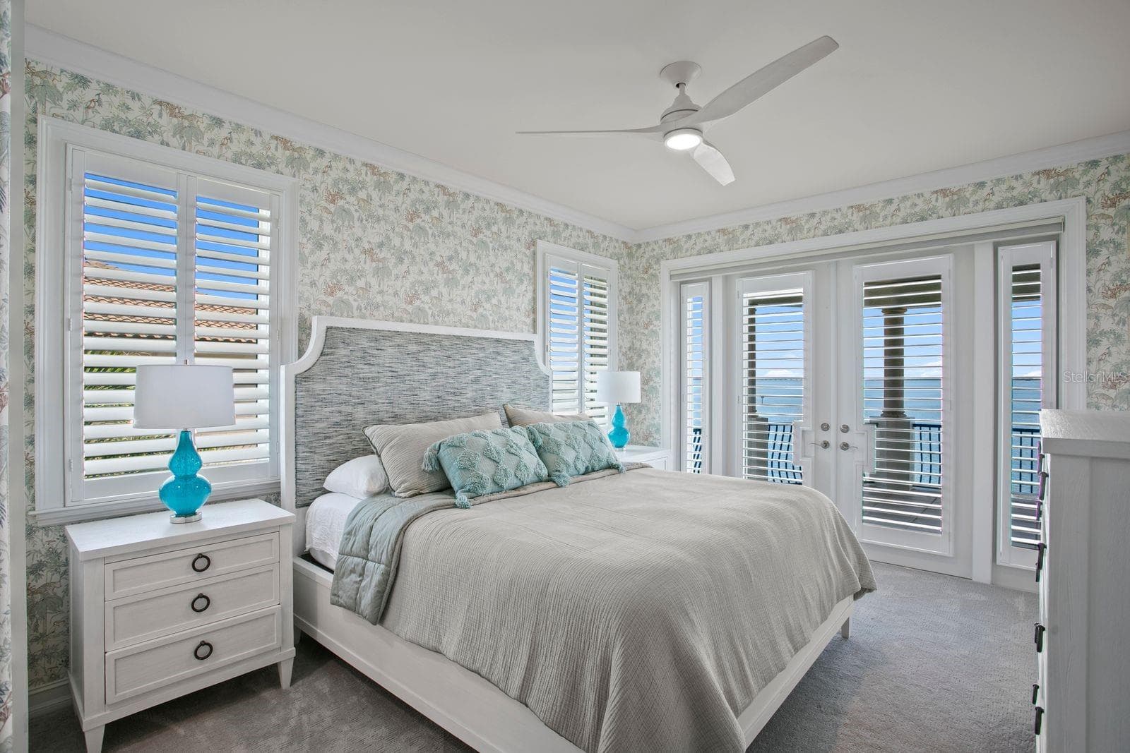 Top-leel bedroom two with French doors opening onto a private balcony. - 611 1ST AVE S, TIERRA VERDE