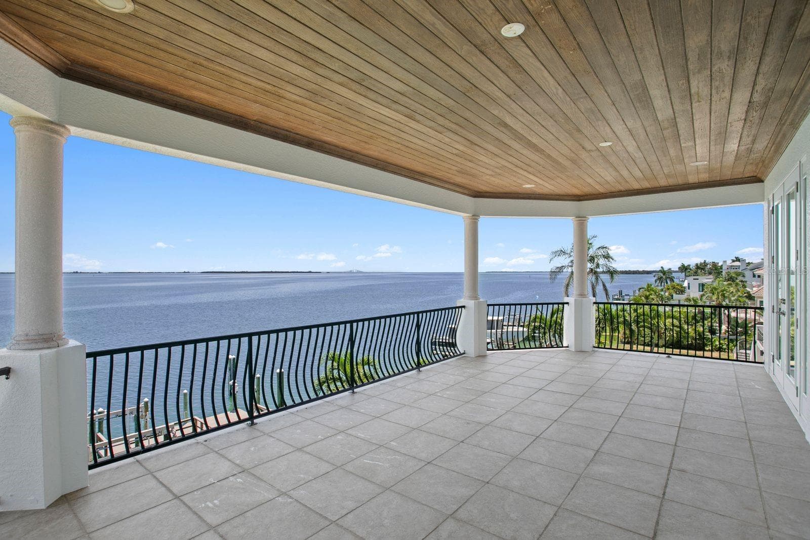 Spacious top level balcony connecting to bedrooms two and three. - 611 1ST AVE S, TIERRA VERDE