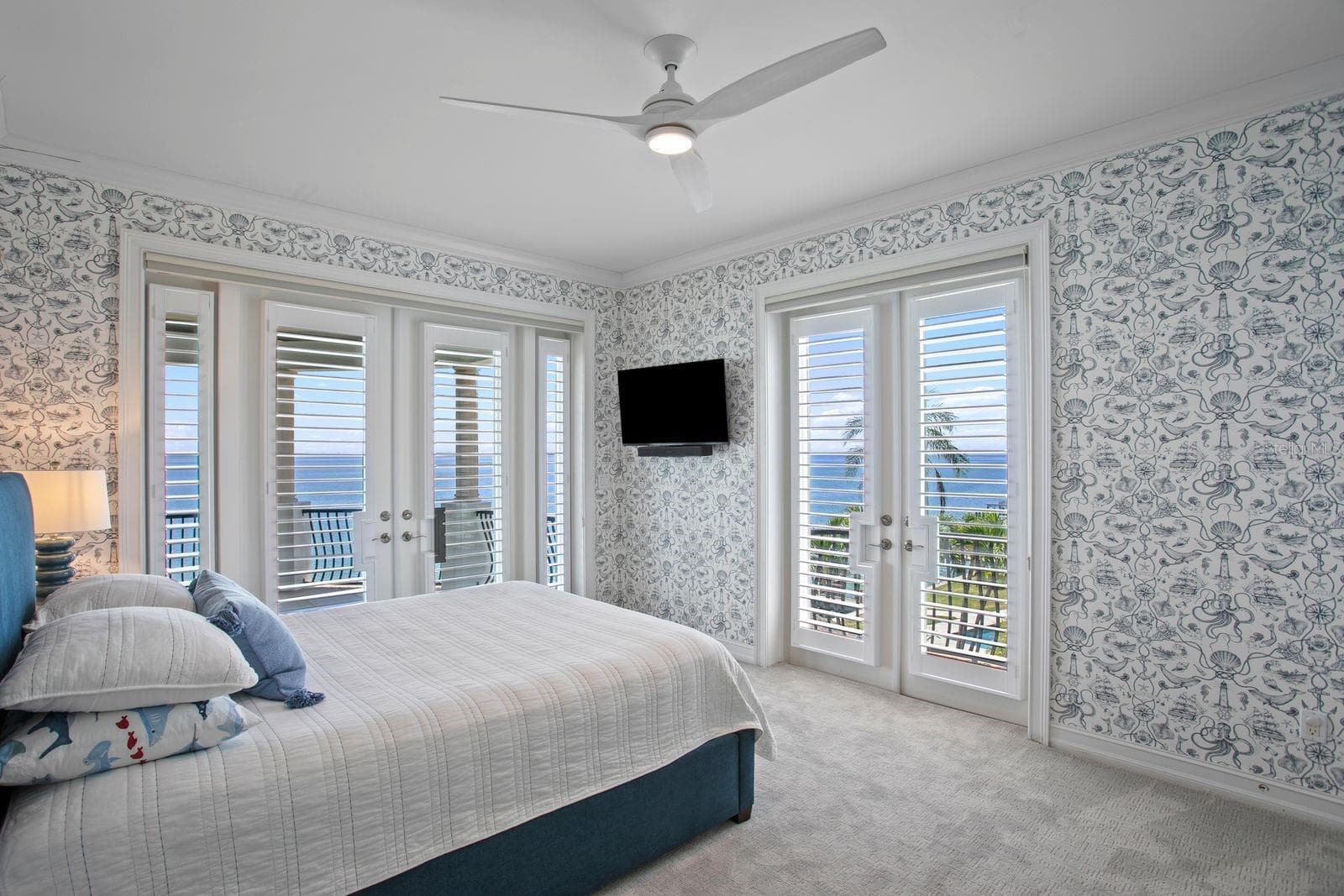 Top level, bedroom three with French doors opening to a breathtaking balcony with ocean views. - 611 1ST AVE S, TIERRA VERDE