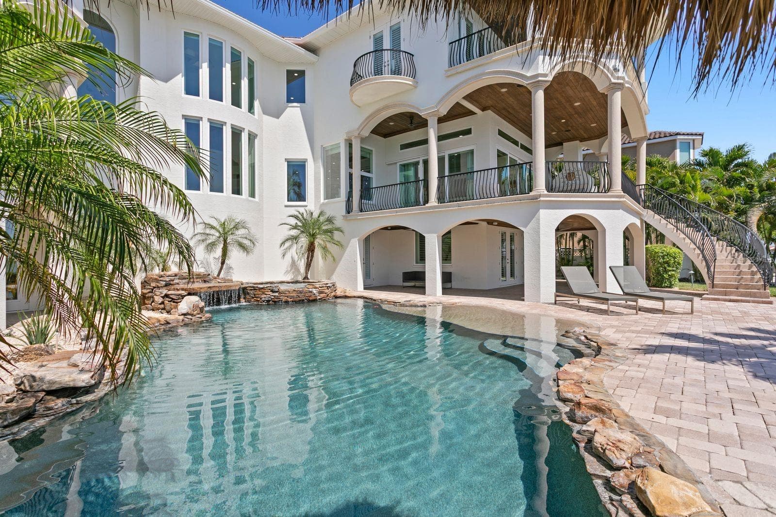 Serene lagoon pool and spa with a waterfall - 611 1ST AVE S, TIERRA VERDE