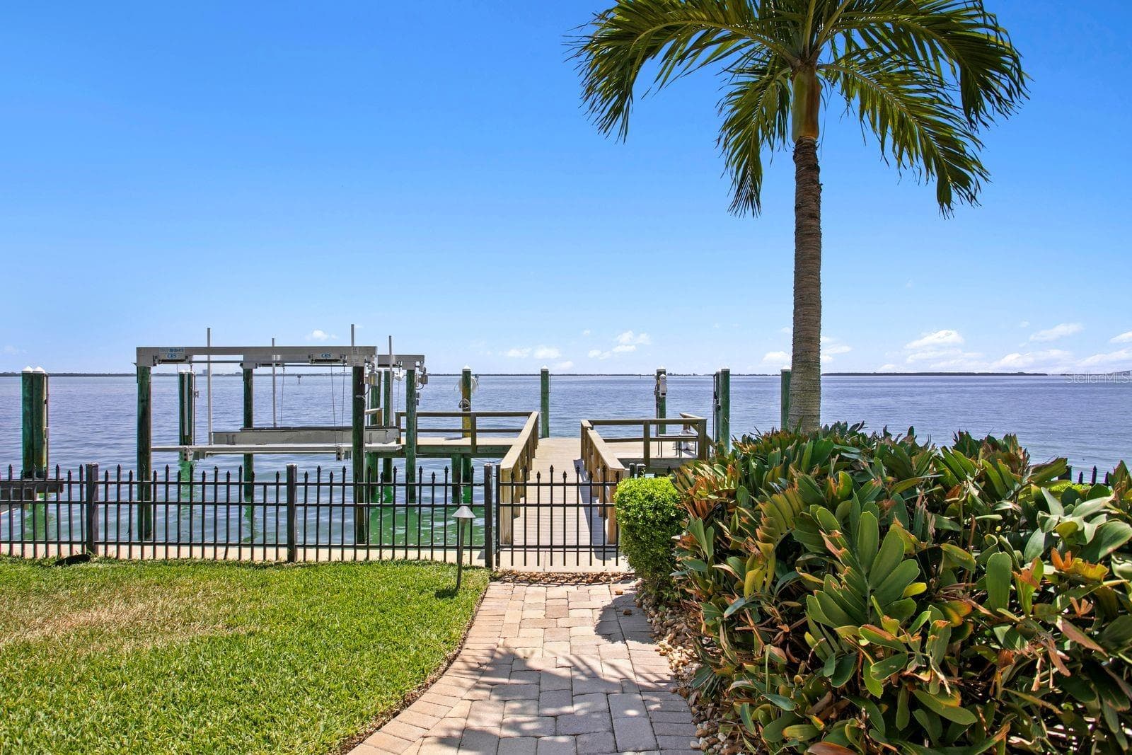 The residence includes a 10,000lb boat lift, a jet ski lift and a generous boat slip. - 611 1ST AVE S, TIERRA VERDE