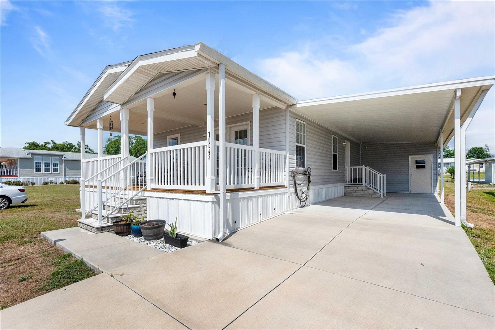Wide carport on this newer home. - 10042 COLLINGWOOD AVE, DADE CITY