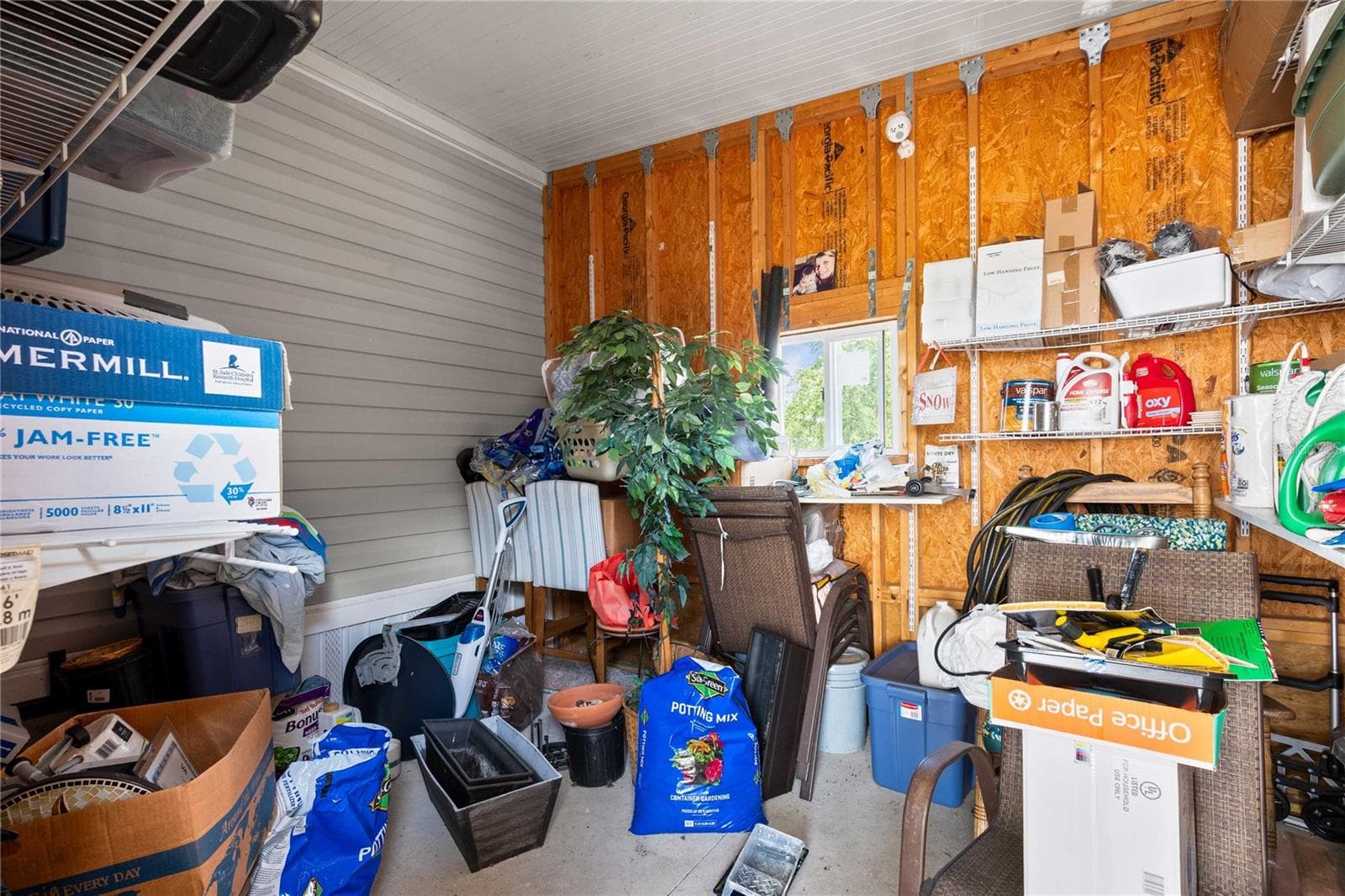 Storage shed is attached to carport. - 10042 COLLINGWOOD AVE, DADE CITY