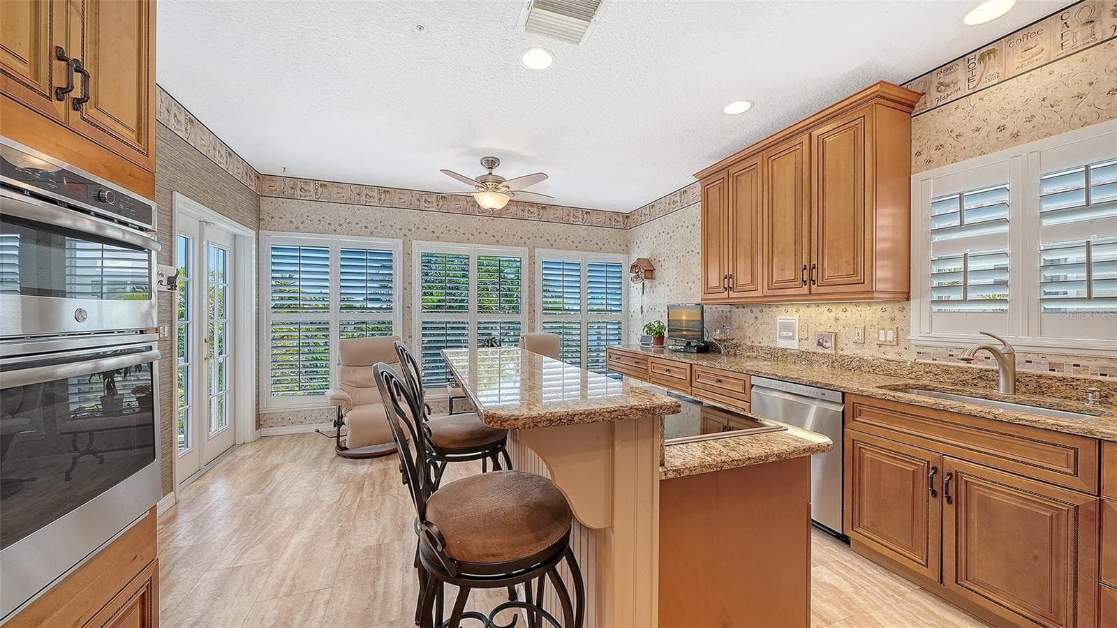 Perfect chef's kitchen with a breakfast bar, featuring all Stainless appliance package and loads of storage including a pantry wall plus built in microwave/wall oven combination and induction range! - 3040 GULF OF MEXICO DR #3, LONGBOAT KEY