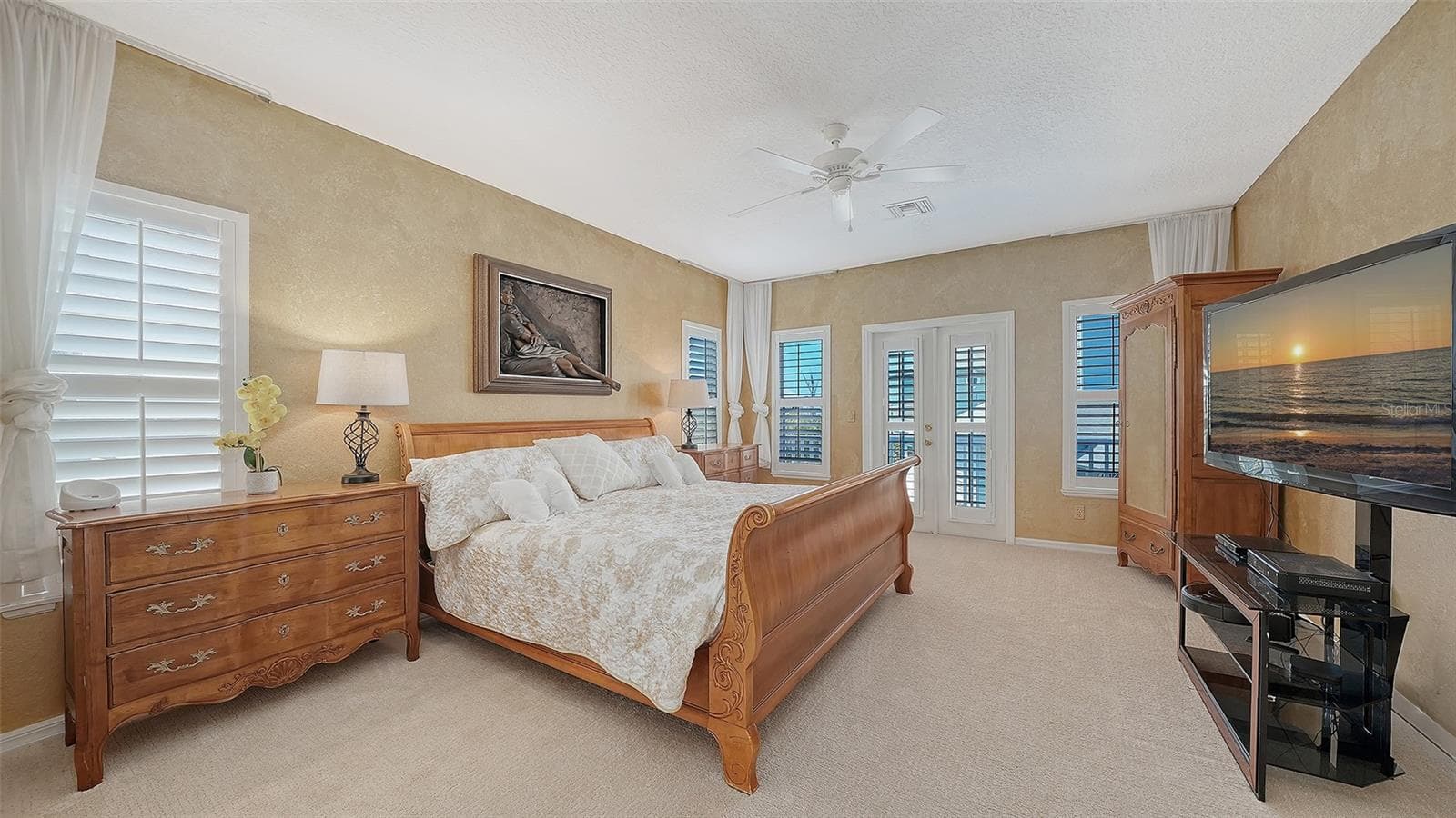 The primary suite offers a private retreat with generous proportions and a spa-inspired en-suite bath and a julette balcony with peekaboo views of the Gulf across the street. - 3040 GULF OF MEXICO DR #3, LONGBOAT KEY