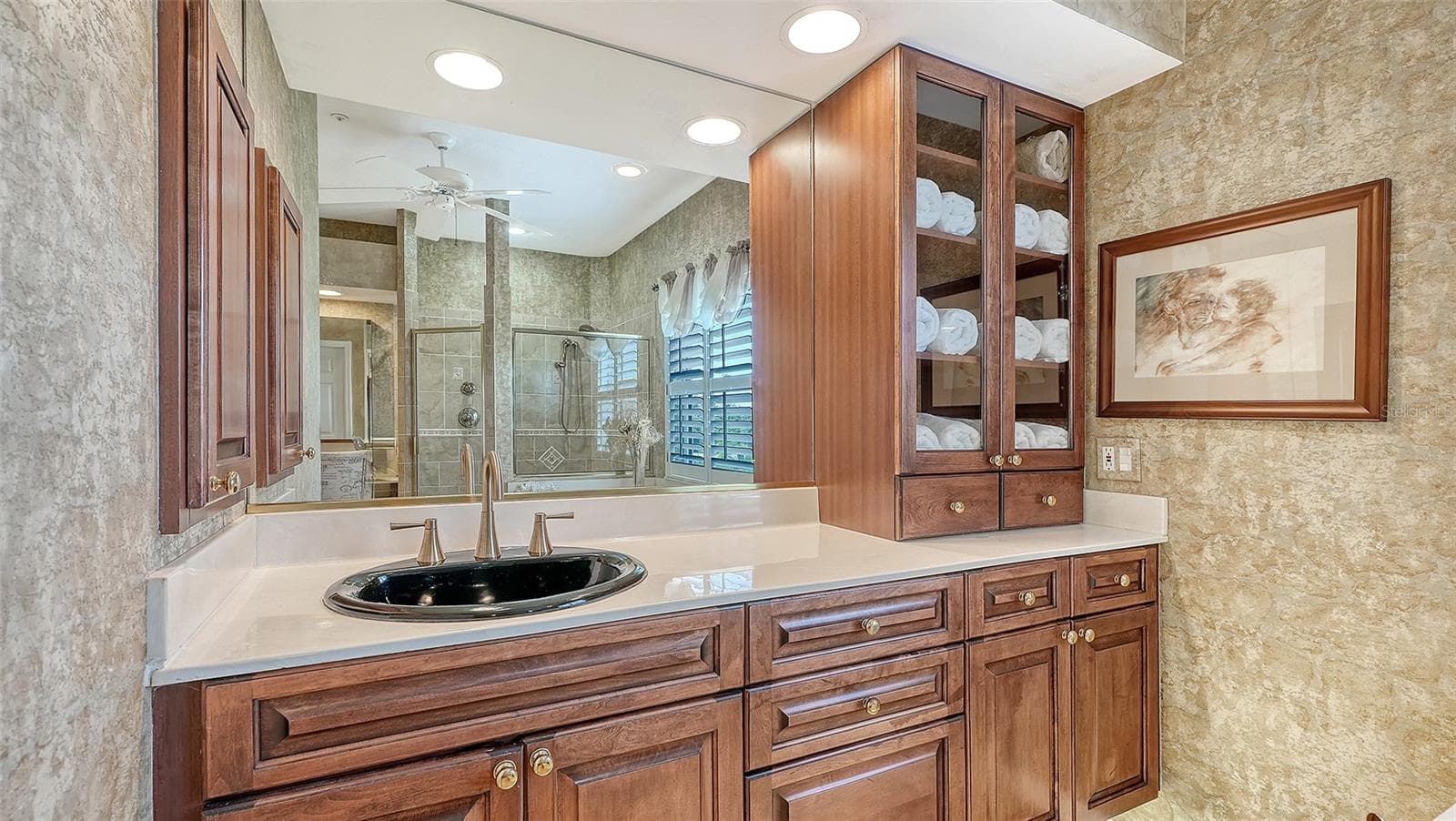 Your private retreat with a spa-inspired en-suite bath features generous storage, dual vanities, makeup vanity, soaking tub and separate shower with upgraded fixtures and specialty tiling details and new showerhead. - 3040 GULF OF MEXICO DR #3, LONGBOAT KEY
