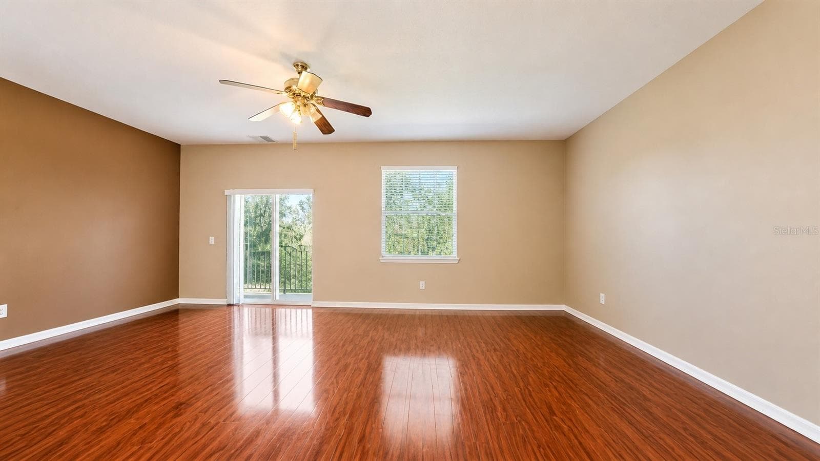 Spacious living room looking out the back door toward the pond. - 4116 ORANGE TREE CT, ST CLOUD