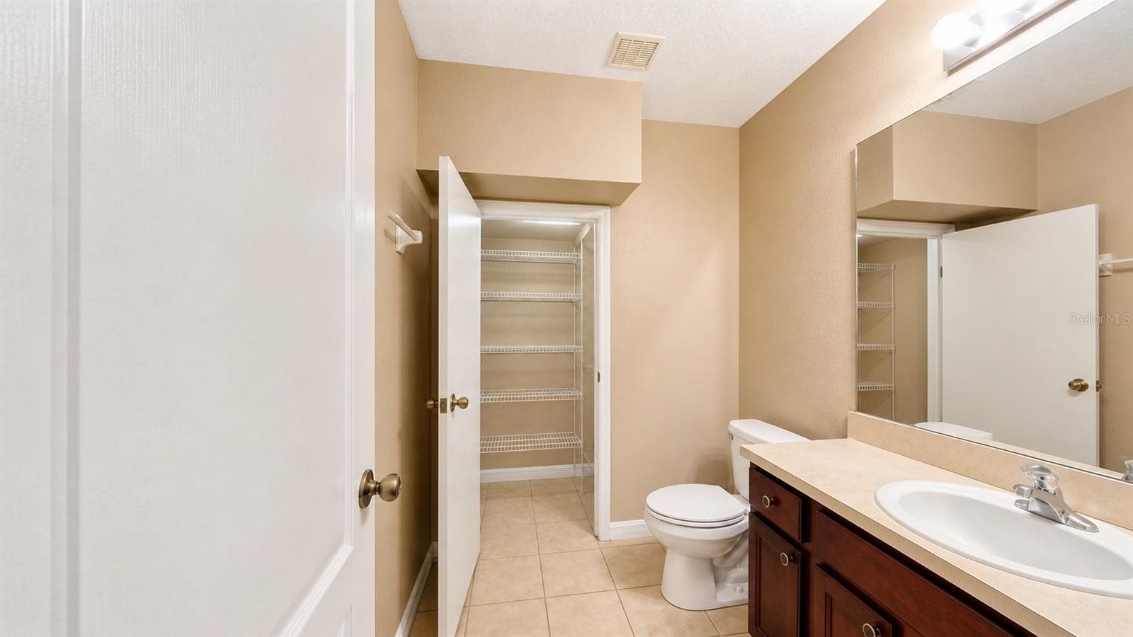 Half bathroom with extra storage on the first floor. - 4116 ORANGE TREE CT, ST CLOUD