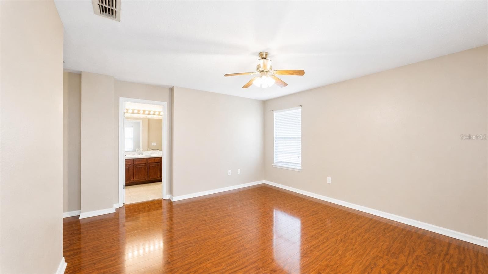 Primary bedroom has an ensuite bathroom with a walk-in closet. - 4116 ORANGE TREE CT, ST CLOUD