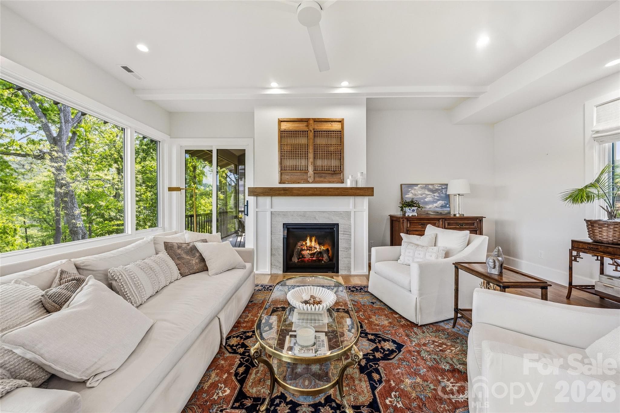Gas fireplace and walls of windows. - Asheville