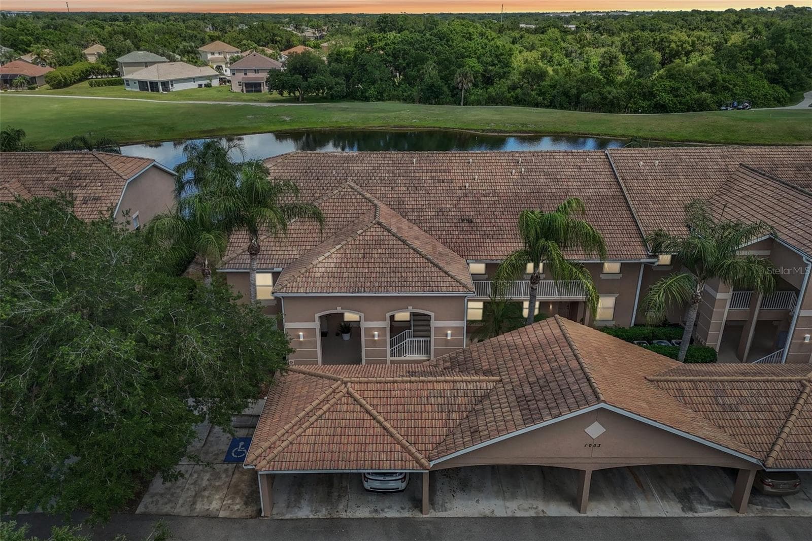 DRONE VIEW OVERLOOK THE FRONT AND BACK OF THE PROPERTY - 1003 FAIRWAYCOVE LN #201, BRADENTON