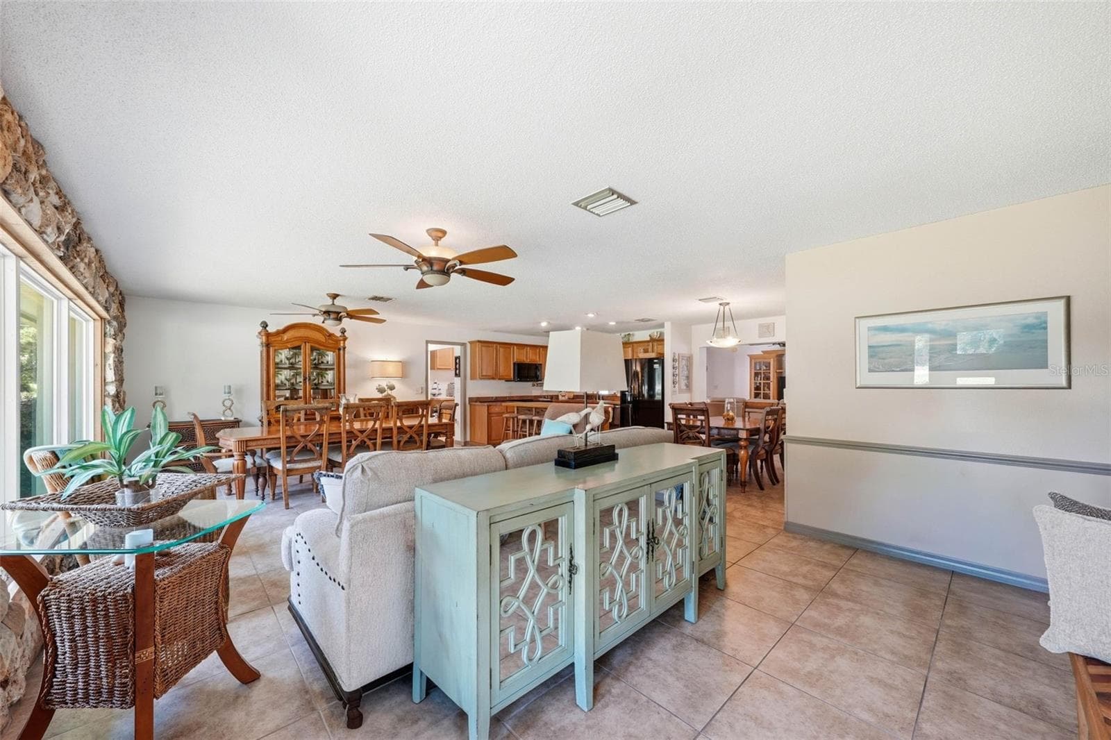 View upon entering the front door into the entry foyer-Great room and kitchen area - 37237 GRAYS AIRPORT RD, LADY LAKE