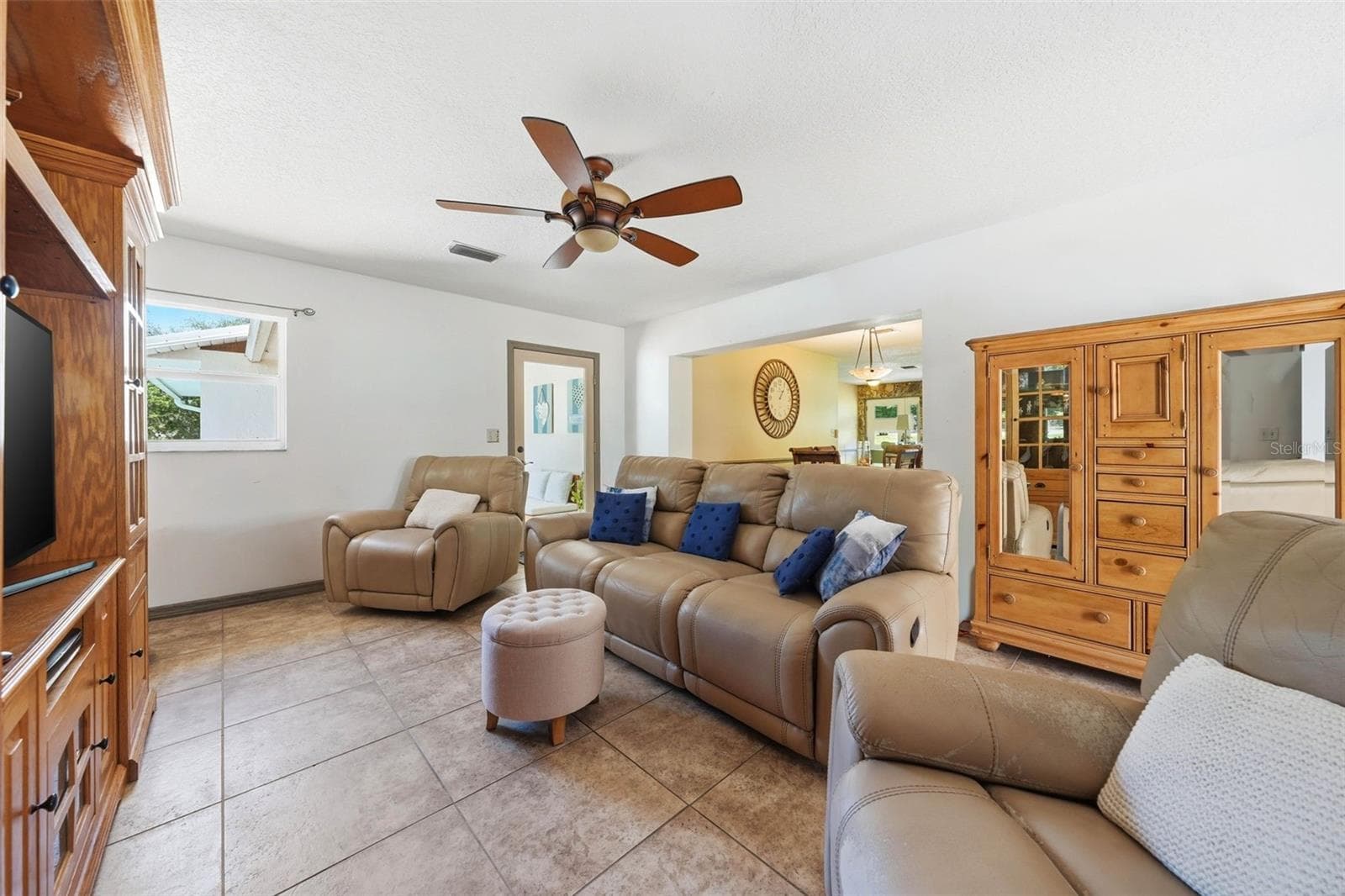 Family room showing door to the screened porch and kitchen dining beyond - 37237 GRAYS AIRPORT RD, LADY LAKE