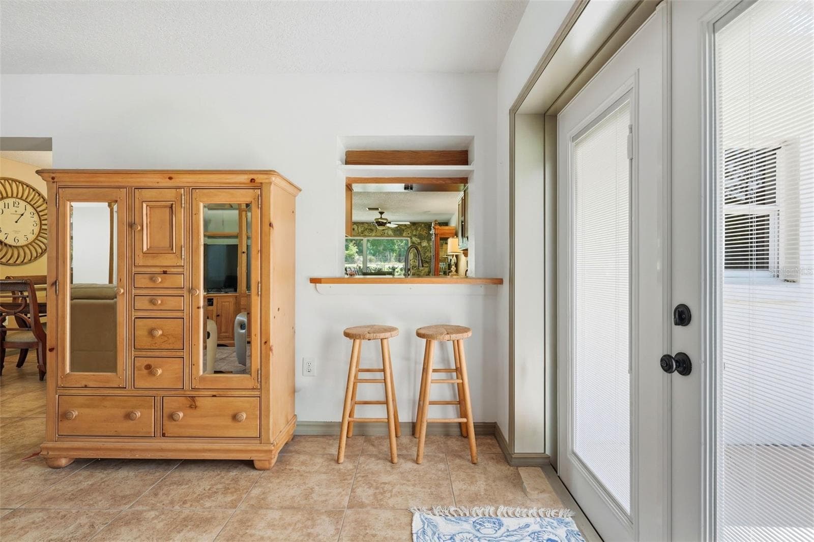 Family room showing the pass-through to the kitchen and French doors to the side patio - 37237 GRAYS AIRPORT RD, LADY LAKE