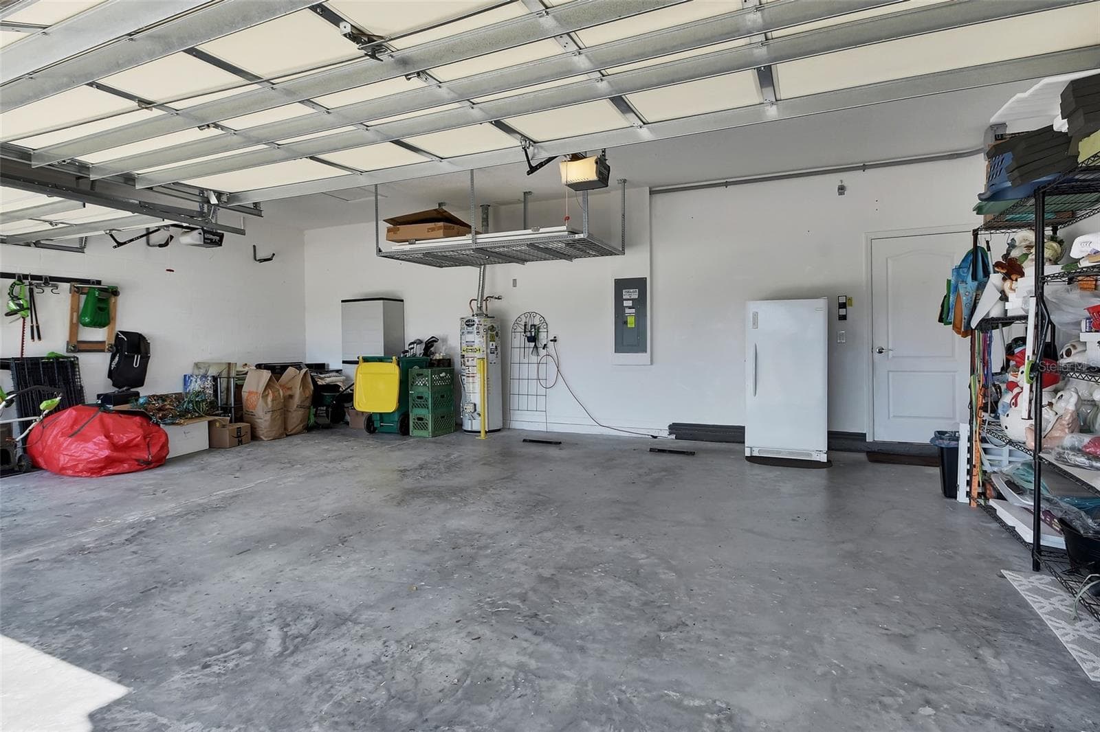 3 Car Garage with hanging storage - 337 ORCHARD HILL ST, DELAND