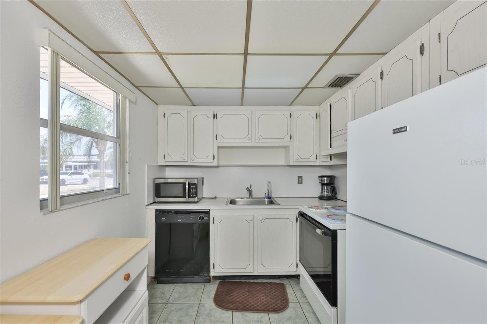 LONG SHOT OF GALLEY KITCHEN - 1802 BEDFORD TER #177, SUN CITY CENTER