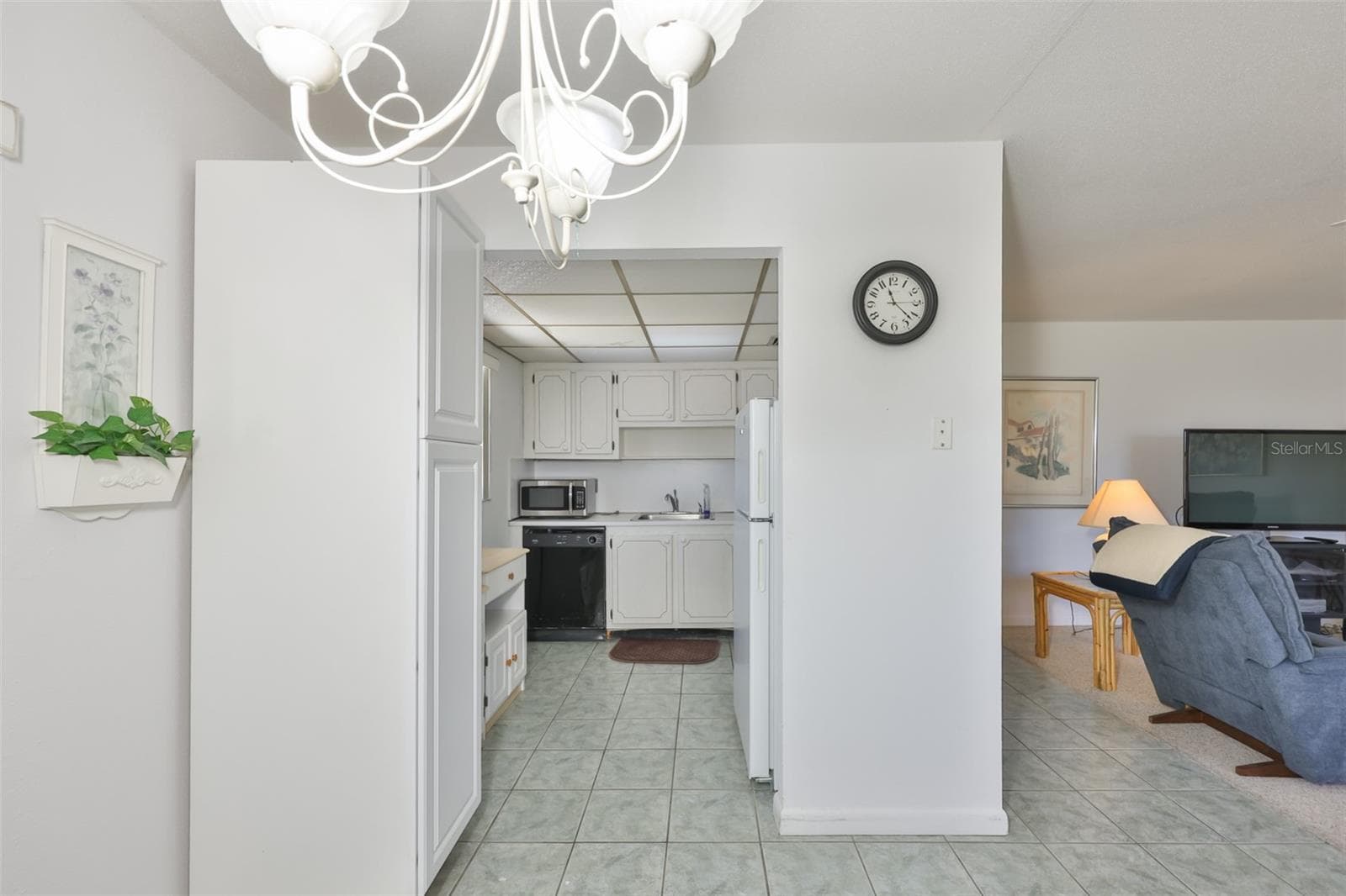 LONG SHOT OF KITCHEN FROM FRONT DOOR - 1802 BEDFORD TER #177, SUN CITY CENTER