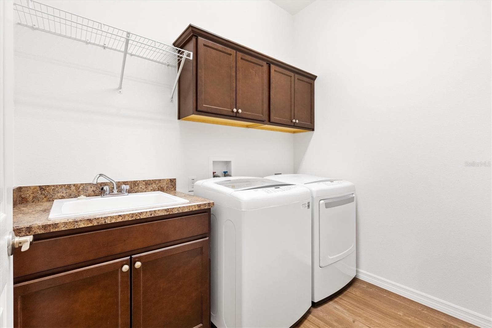 Large laundry room with built-in sink and cabinetry. - 4348 TUSCALOOSA PATH, THE VILLAGES