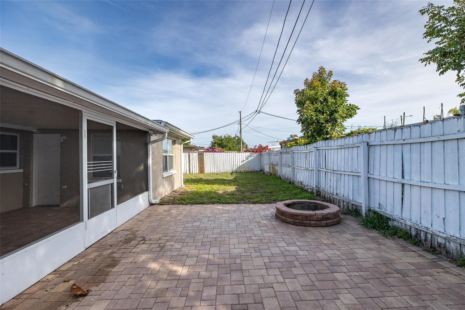 Pavers in Backyard with Firepit - 1148 FERNWOOD DR, HOLIDAY
