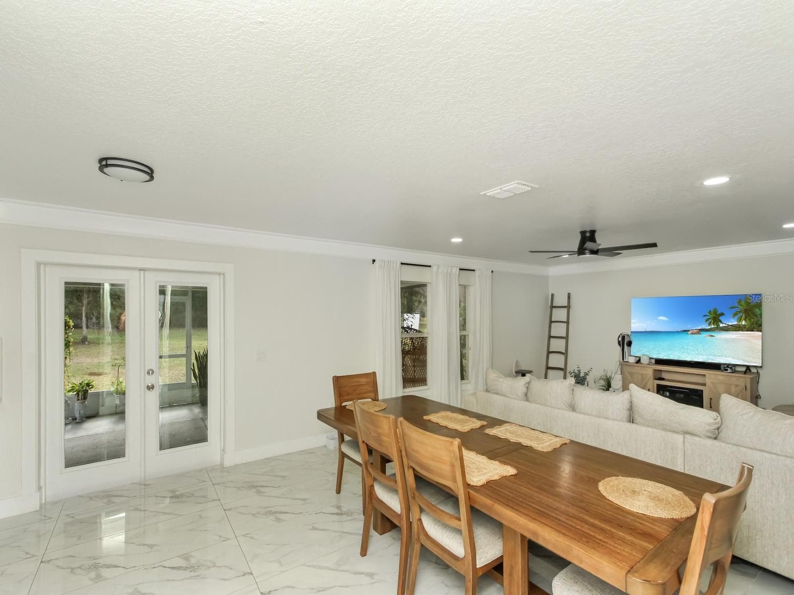 the custom crown molding and french doors really add a touch of timeless elegance to this home. - 7561 LAKE ANDREA CIR, MOUNT DORA