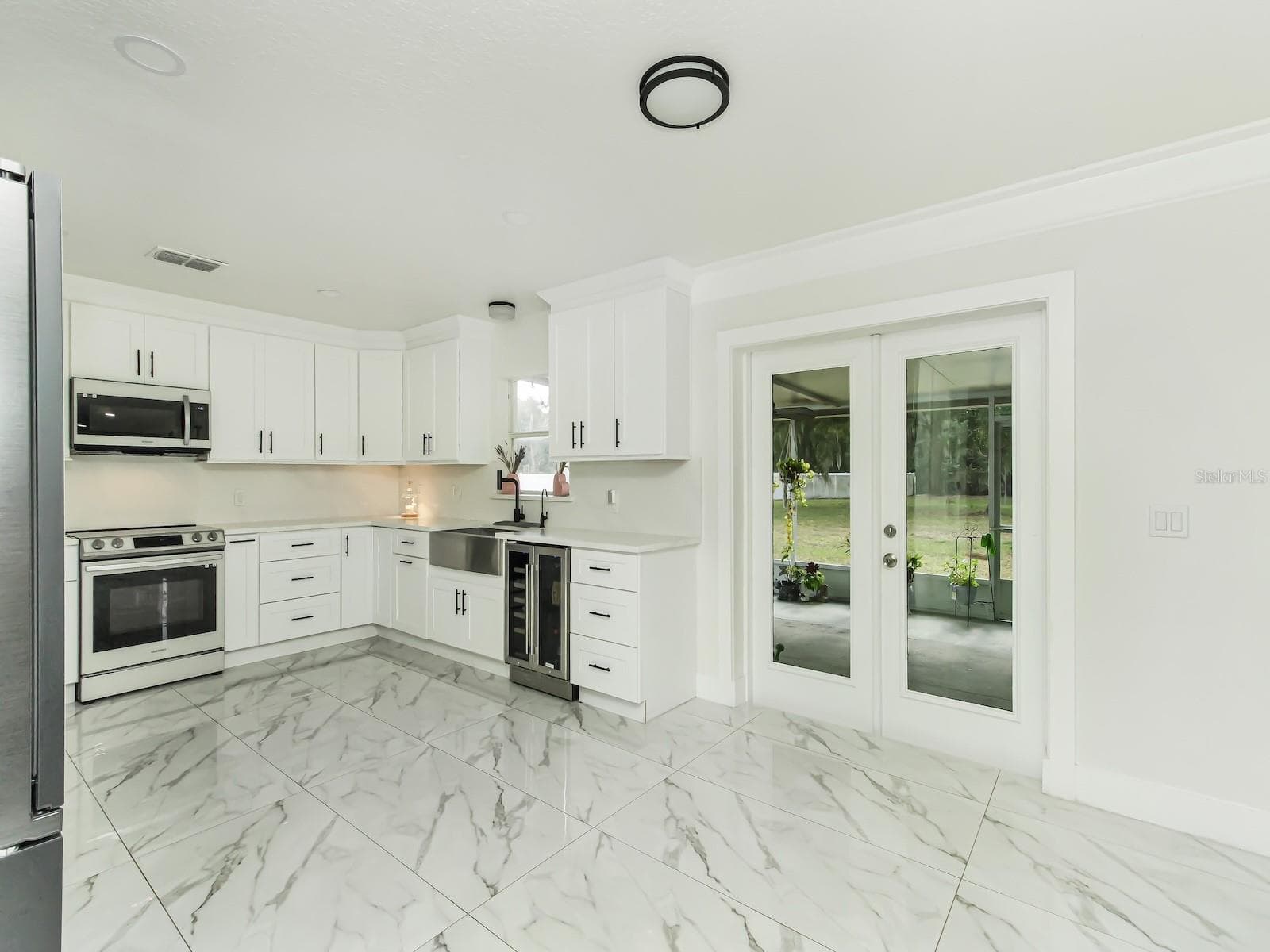The custom kitchen was completely installed with a cooks mind. Big farmer sink and plenty of counter space. - 7561 LAKE ANDREA CIR, MOUNT DORA